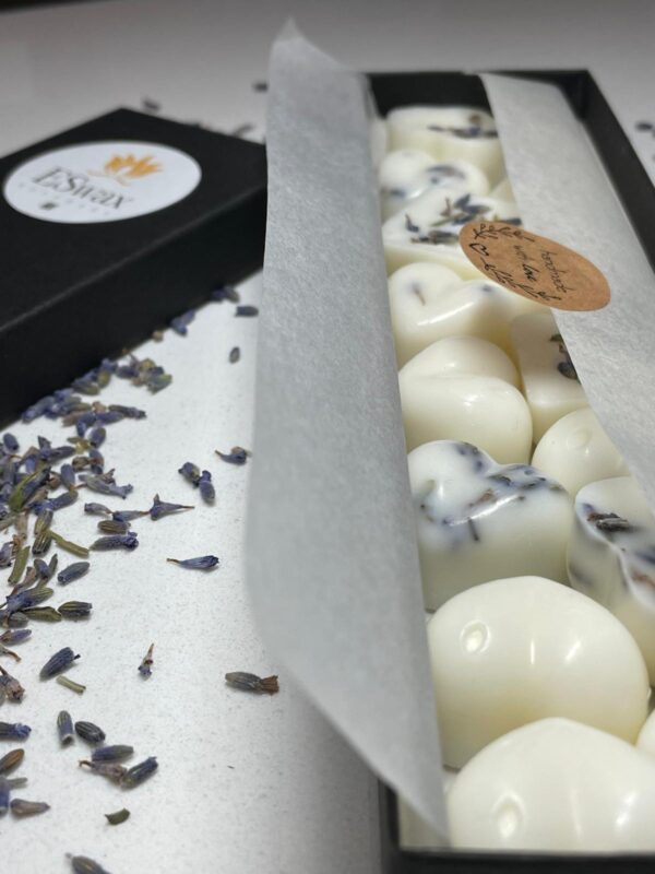 "Handcrafted ESwax wax melts in various scents, arranged on a wooden tray" "Eco-friendly ESwax wax melts made with natural ingredients, displayed next to essential oils" "Collection of ESwax wax melts featuring sustainable packaging and phthalate-free fragrances" "ESwax wax melts emitting a calming aroma, ideal for aromatherapy and relaxation" "Close-up of ESwax wax melts showing their smooth texture and high-quality craftsmanship"